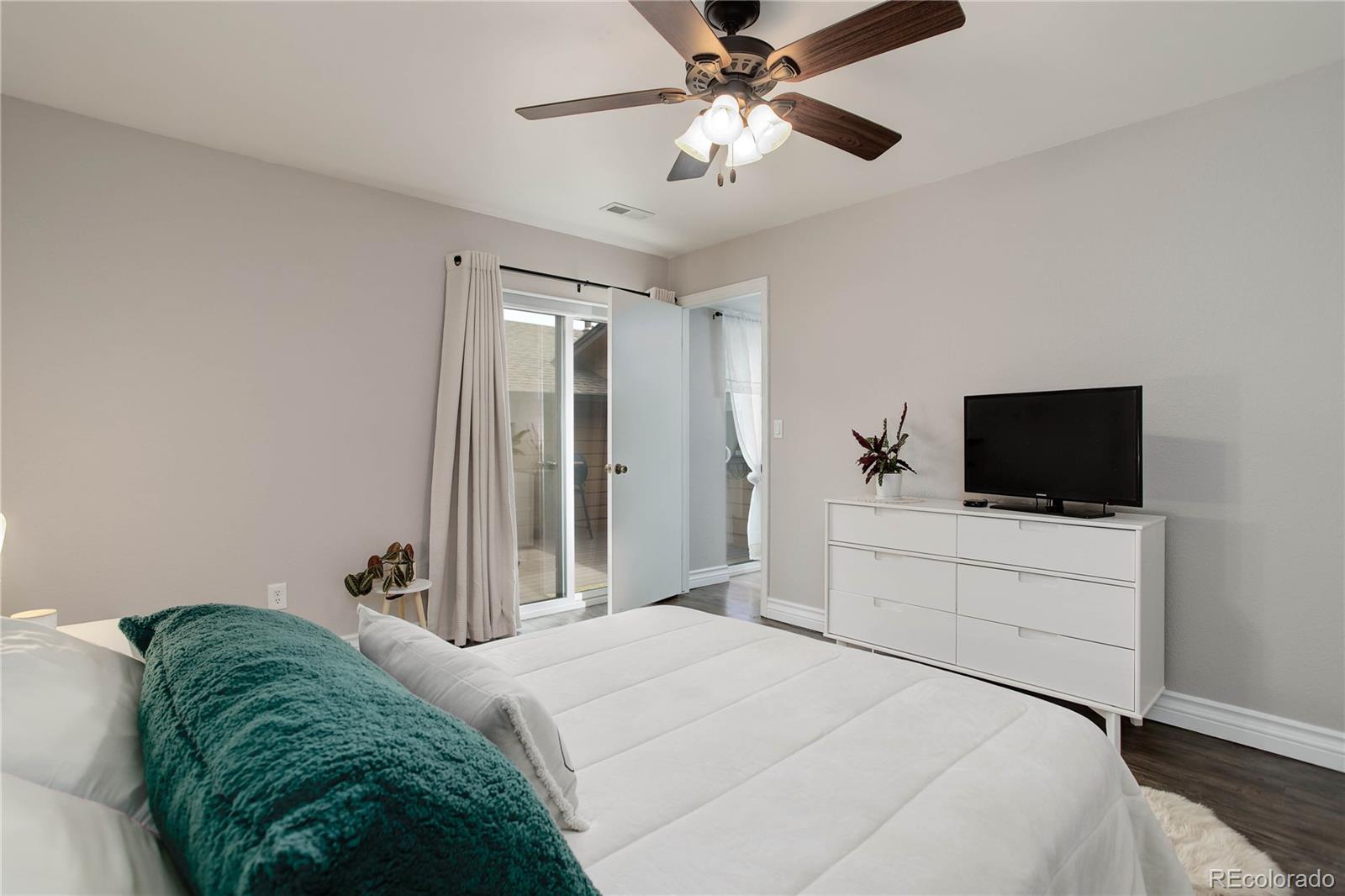 9413 West 89th Circle Westminster, CO 80021 - Photo 17 of 32 a bedroom with a bed and a flat screen tv