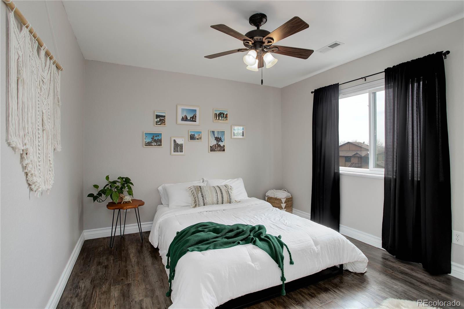 9413 West 89th Circle Westminster, CO 80021 - Photo 22 of 32 a bedroom with a large bed and a chandelier