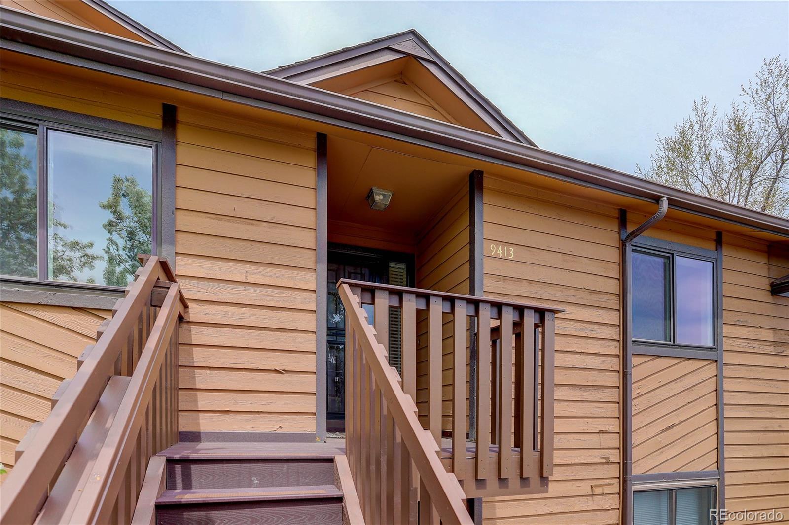 9413 West 89th Circle Westminster, CO 80021 - Photo 3 of 32 a front view of a house with wooden stairs