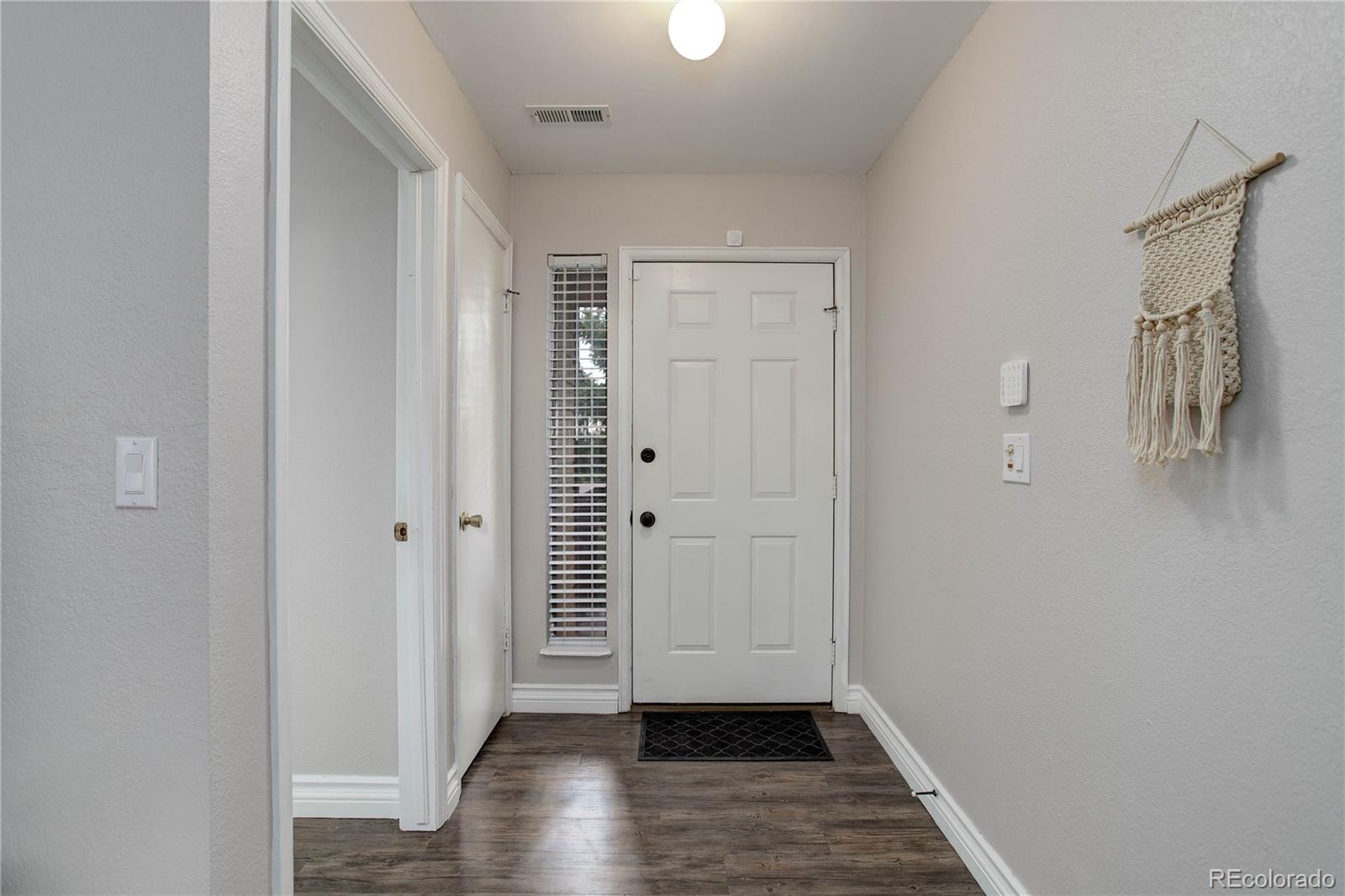 9413 West 89th Circle Westminster, CO 80021 - Photo 5 of 32 a view of a hallway with wooden floor