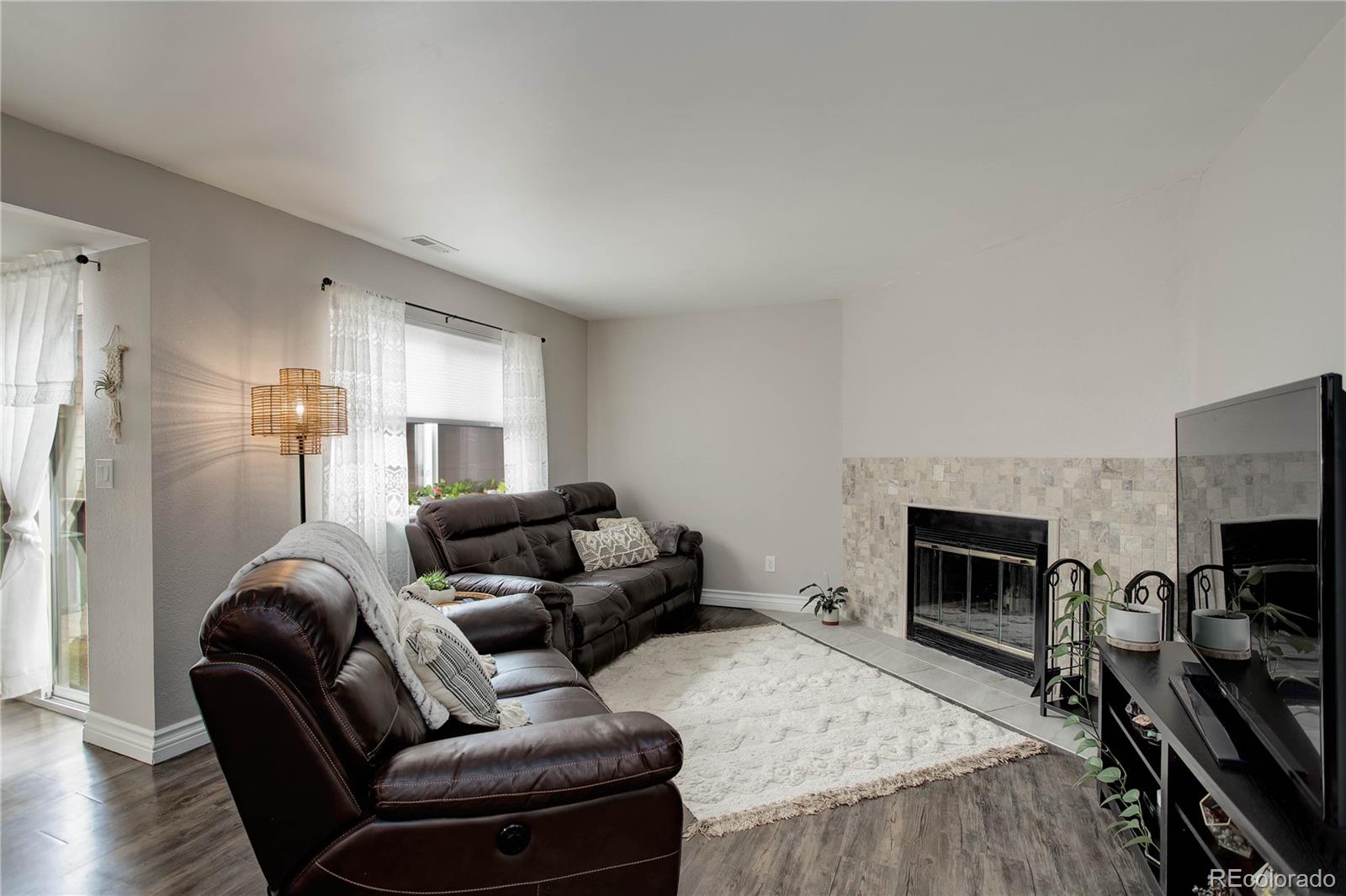 9413 West 89th Circle Westminster, CO 80021 - Photo 7 of 32 a living room with furniture fireplace and flat screen tv