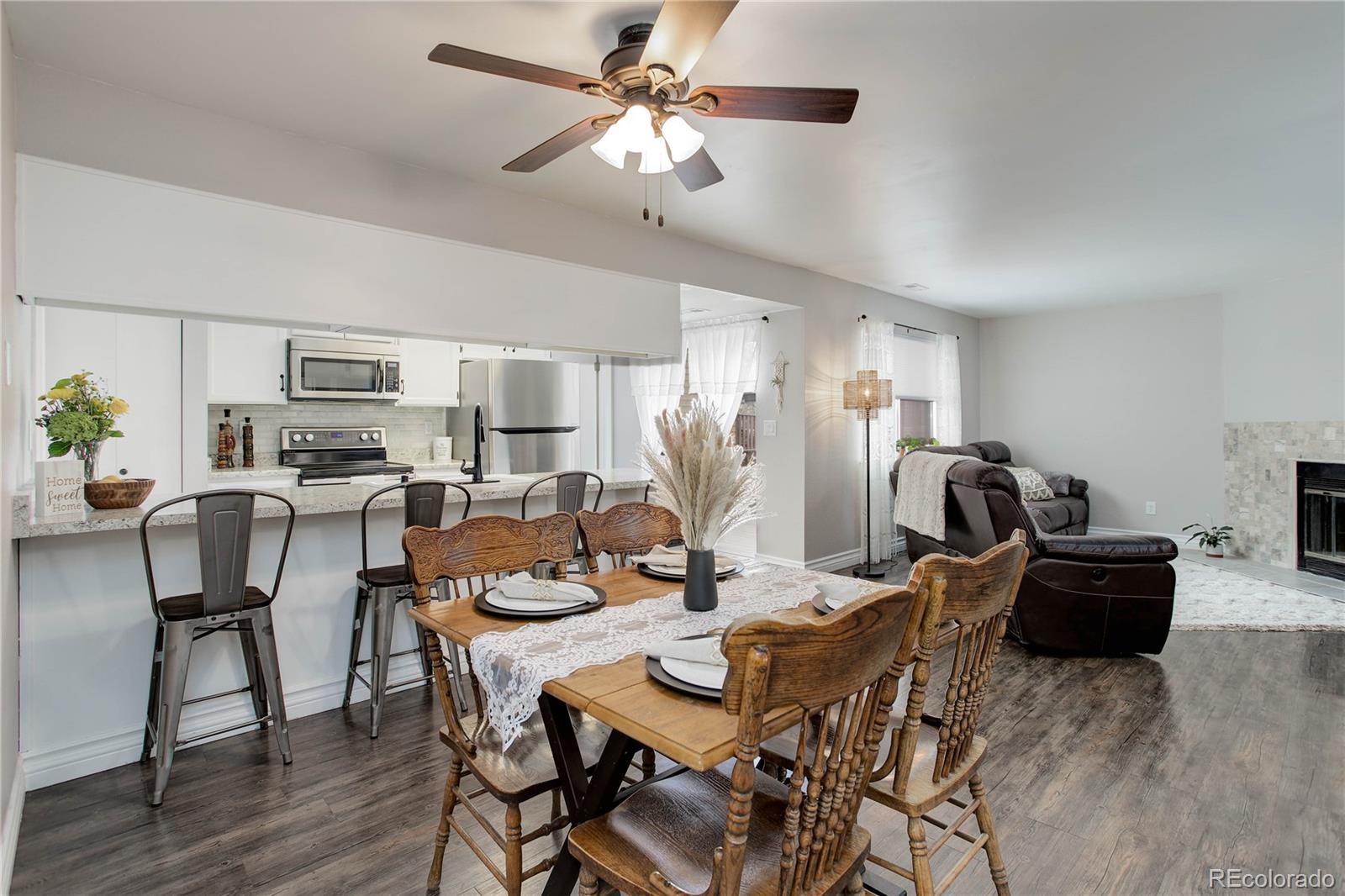 9413 West 89th Circle Westminster, CO 80021 - Photo 10 of 32 a view of a dining room with furniture a chandelier and wooden floor