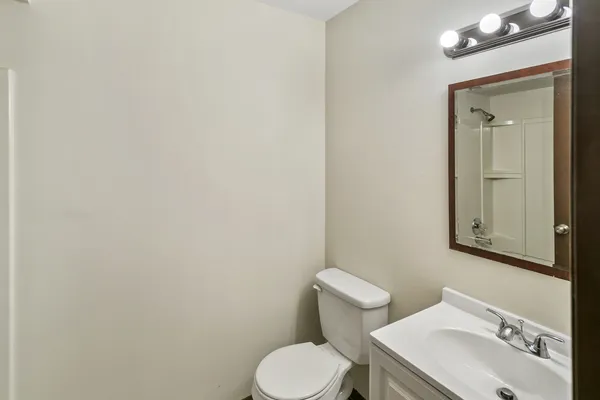 a white toilet sitting next to a bathroom sink