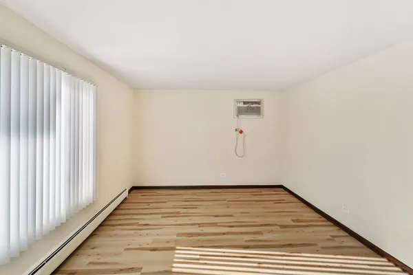 a view of a room with wooden floor and fence