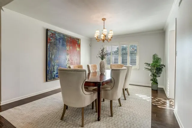 a dining room with furniture potted plants and wooden floor