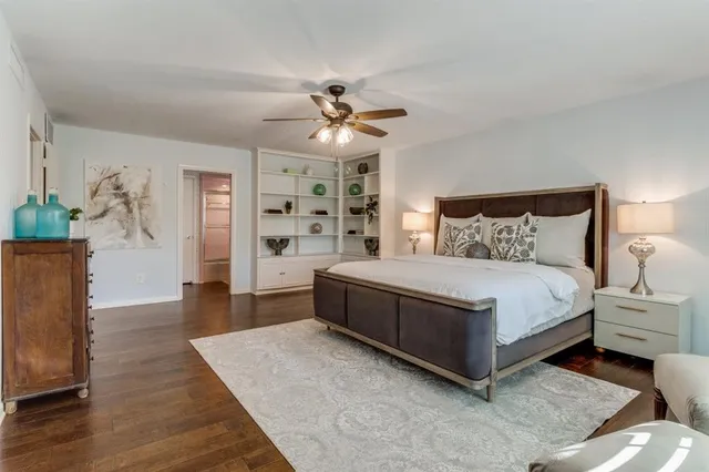 a spacious bedroom with a bed and a chandelier
