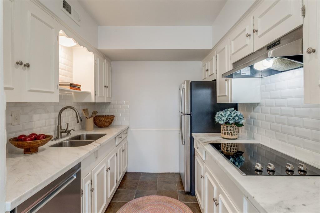 6130 Bandera Avenue, Unit C Dallas, TX 75225 - Photo 7 of 12 a kitchen with stainless steel appliances granite countertop a sink stove refrigerator and cabinets