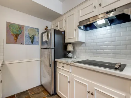 a kitchen with a refrigerator and a sink