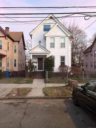 a view of a white house with a patio