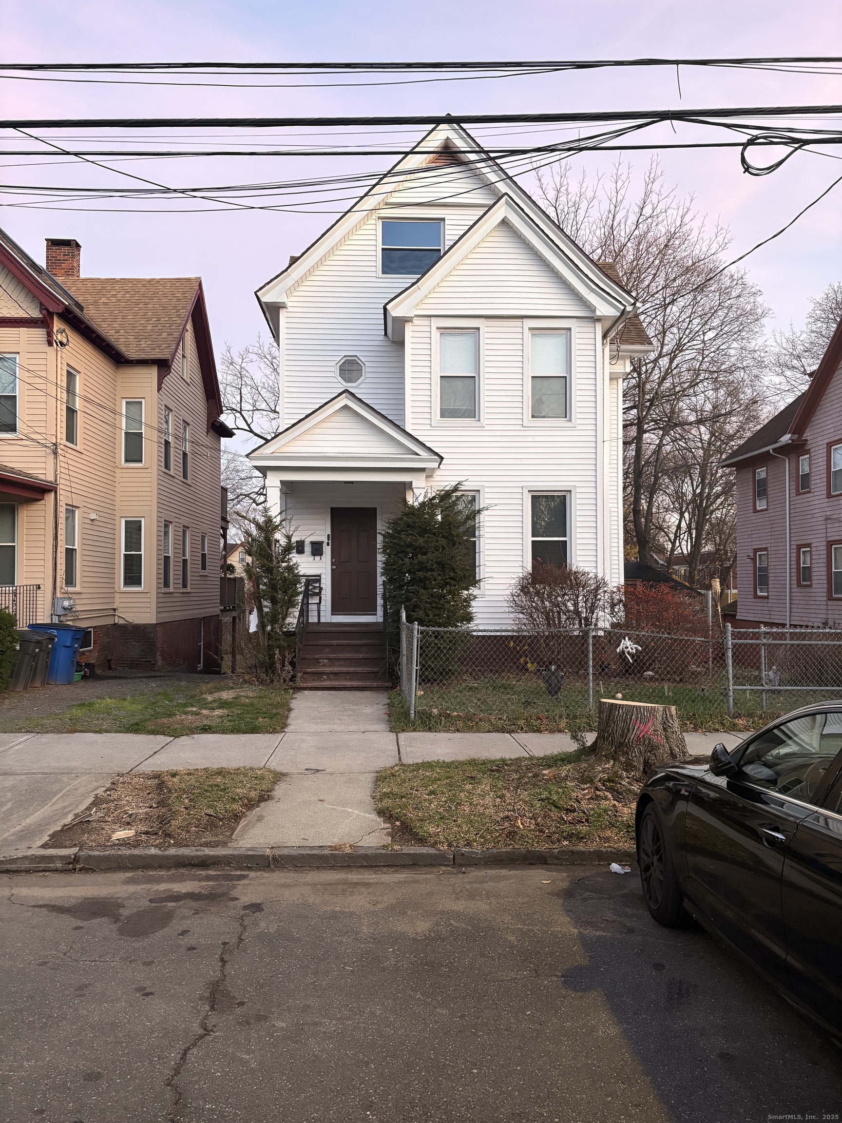 a view of a white house with a patio