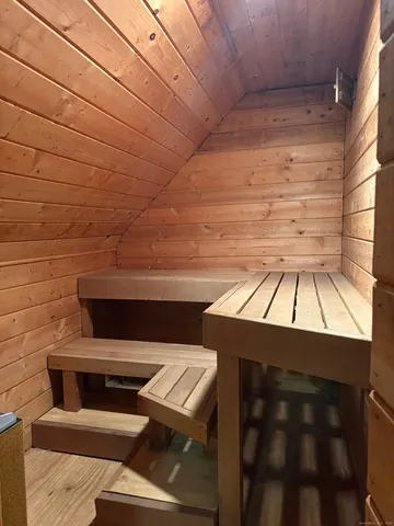 a living room with furniture a rug and a bookshelf