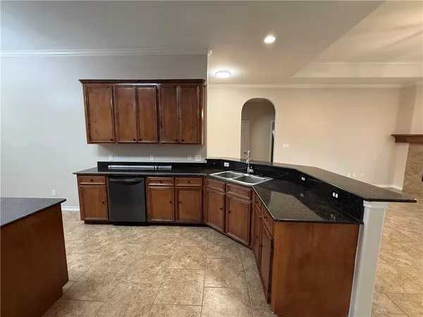 a kitchen with granite countertop a stove and a refrigerator