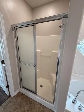 a bathroom with a glass shower door