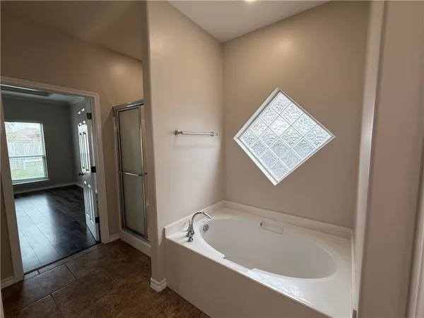 a bathroom with a tub and shower