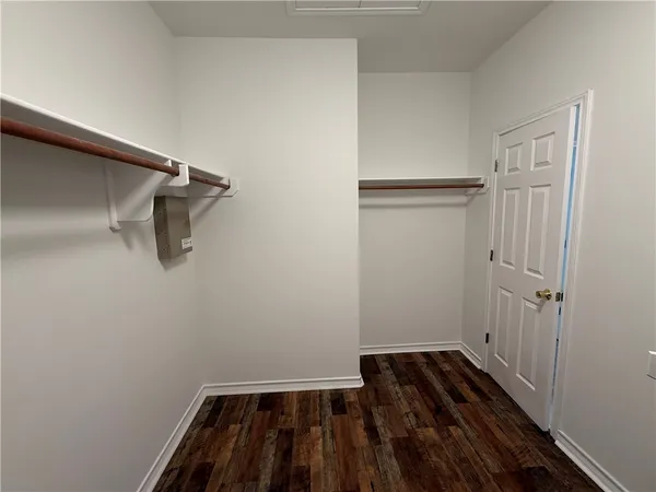 a view of a room with wooden floor and white walls