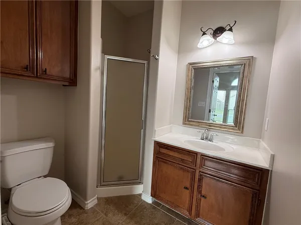 a bathroom with a toilet a sink and mirror