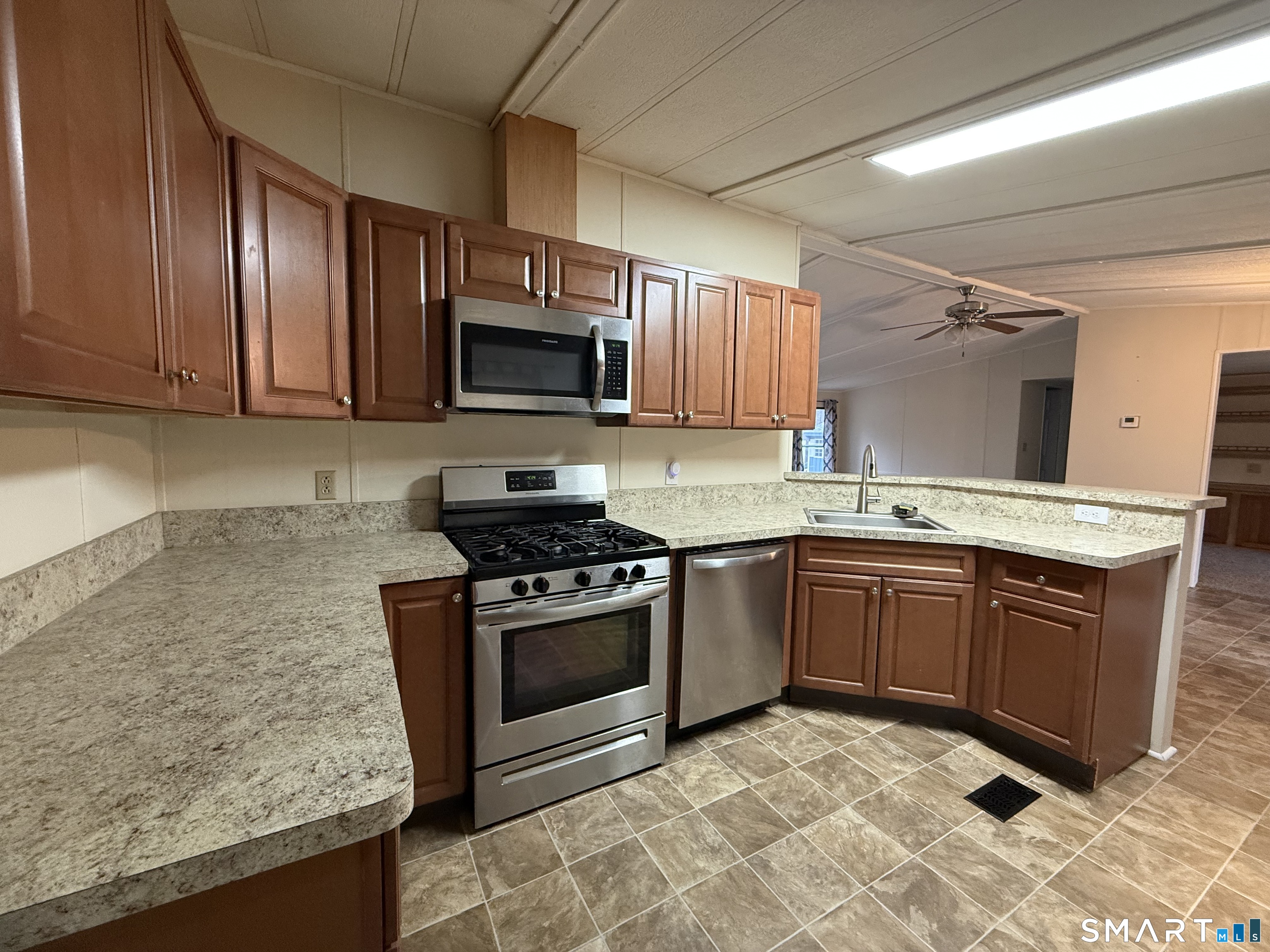 183 Whalehead Road Ledyard, CT 06335 - Photo 11 of 24 a kitchen with granite countertop wooden cabinets and stainless steel appliances