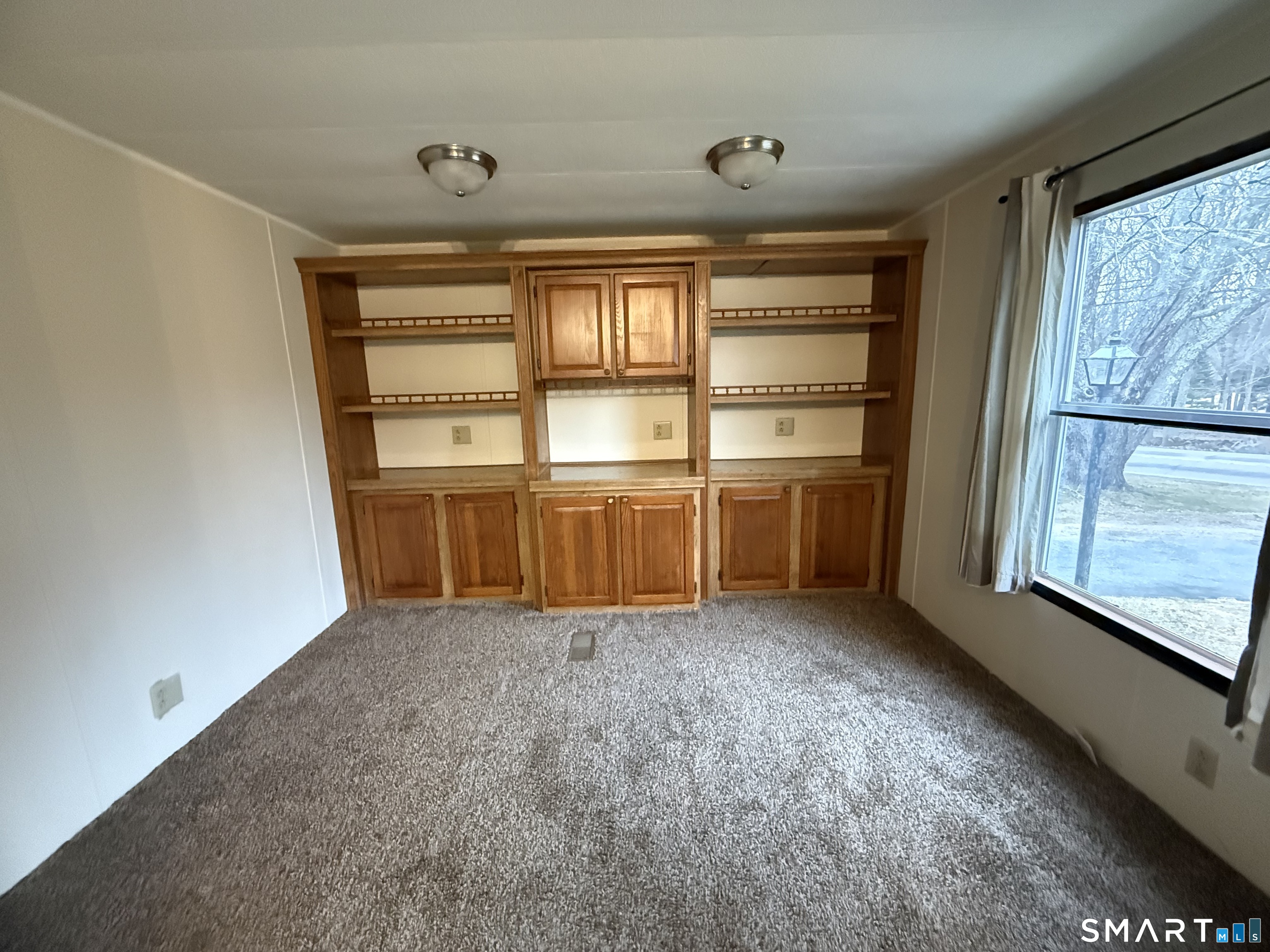 183 Whalehead Road Ledyard, CT 06335 - Photo 12 of 24 an empty room with cabinet and windows