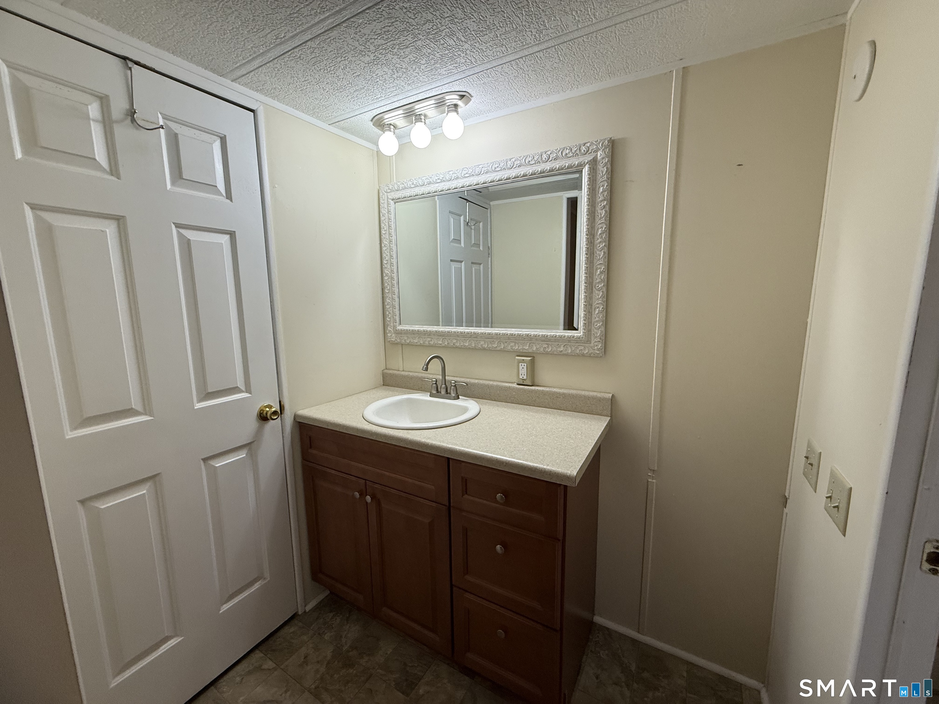 183 Whalehead Road Ledyard, CT 06335 - Photo 16 of 24 a bathroom with a granite countertop sink and a mirror