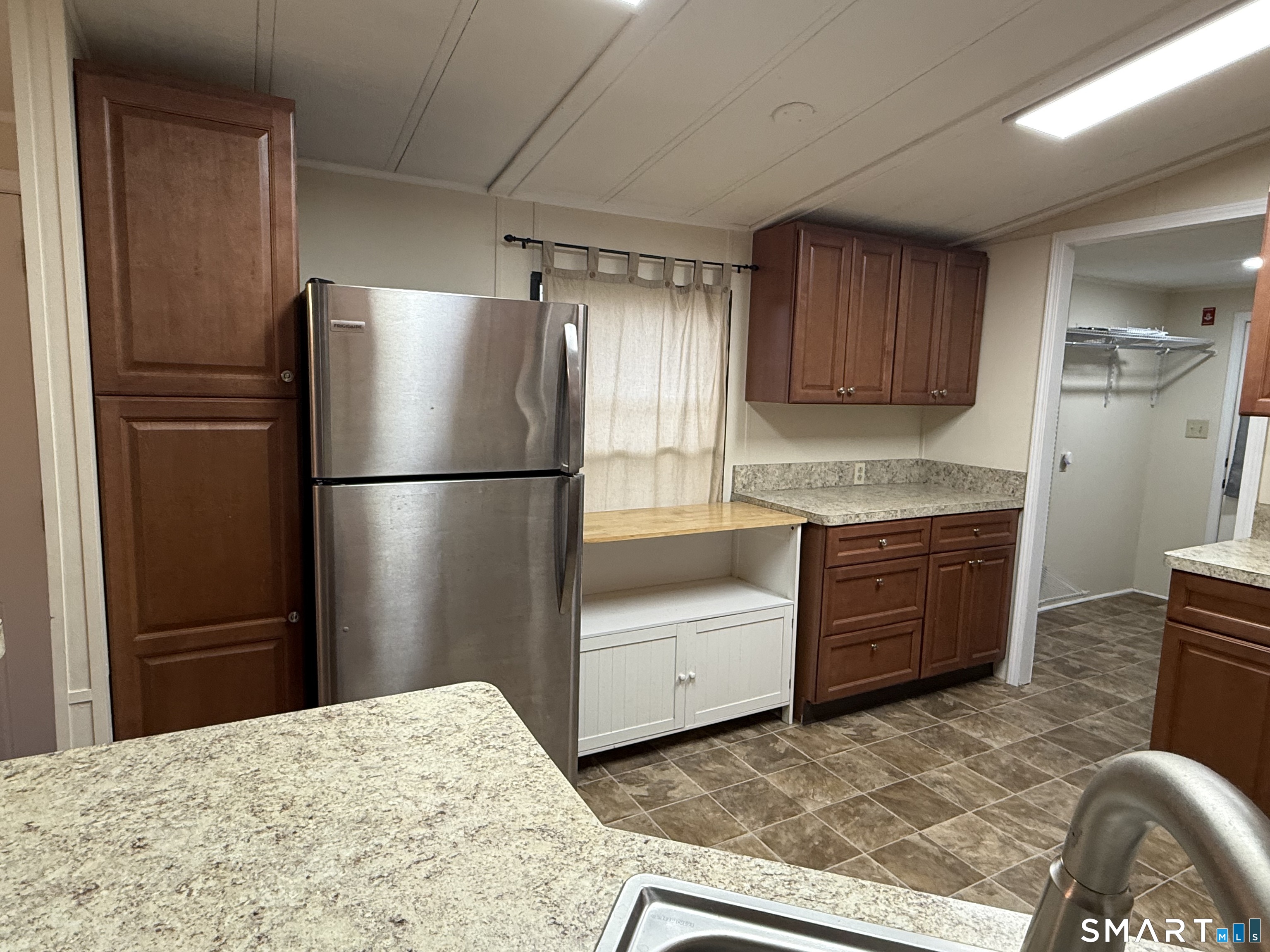 183 Whalehead Road Ledyard, CT 06335 - Photo 10 of 24 a kitchen with granite countertop a refrigerator and a sink
