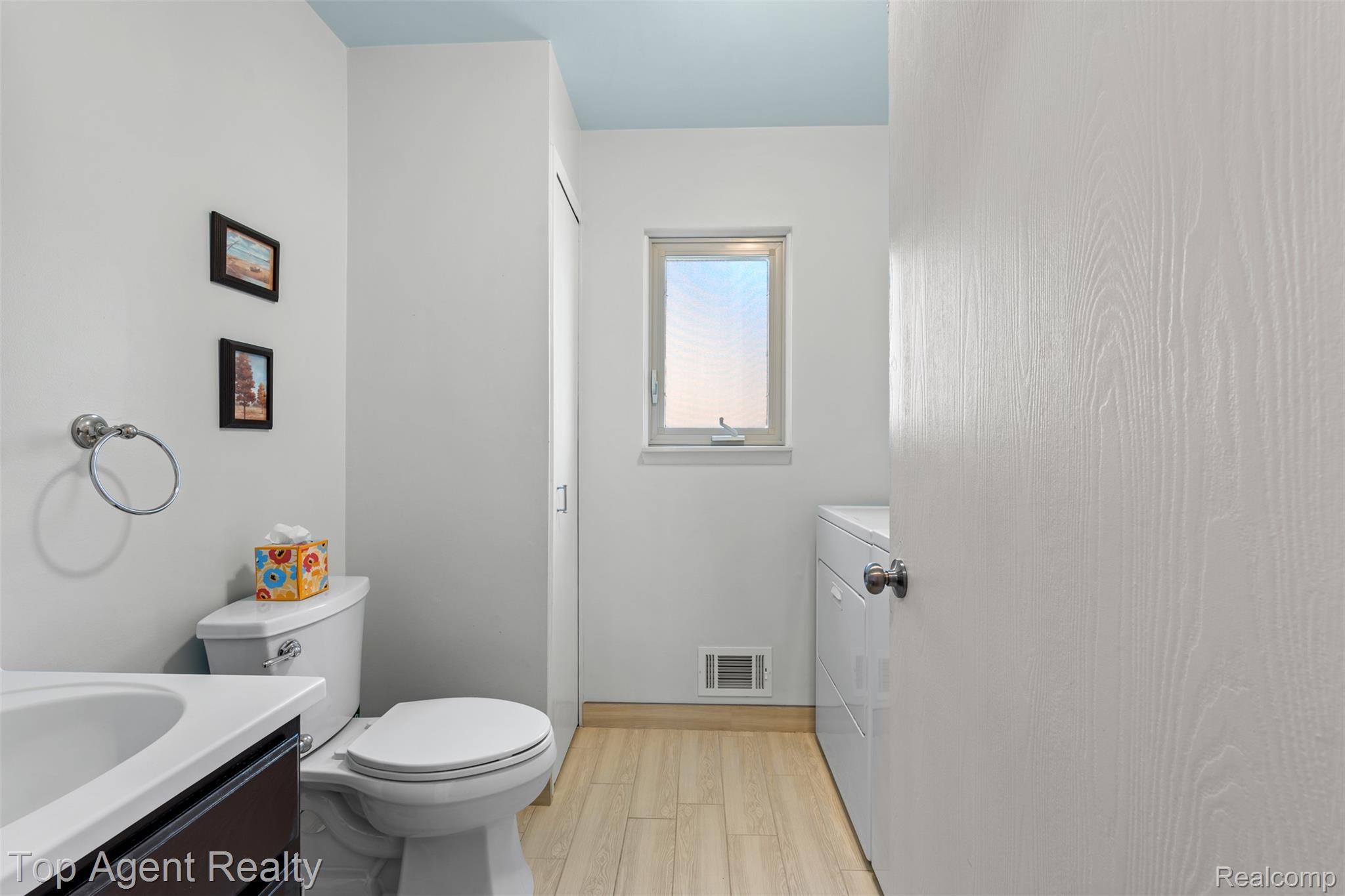 1351 Milverton Road Troy, MI 48083 - Photo 15 of 42 Half bath with vanity, light wood-type flooring, and washer / clothes dryer