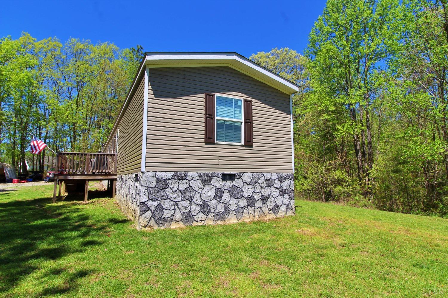 1104 Holiday Lake Road Pamplin, VA 23958 - Photo 15 of 19 a front view of a house with a garden