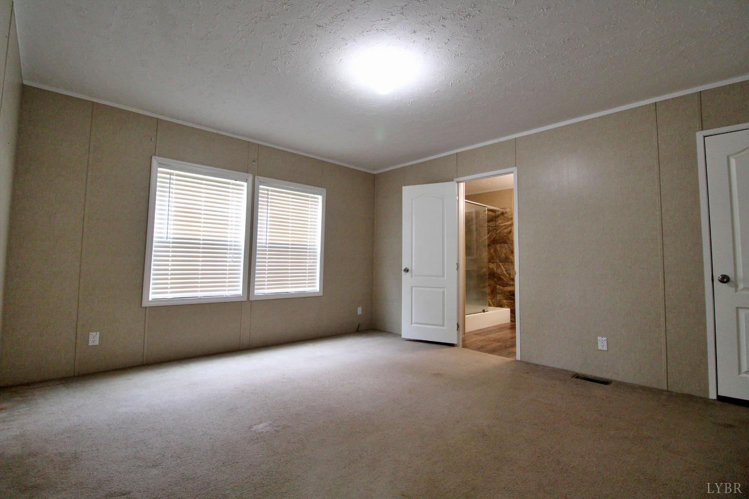 1104 Holiday Lake Road Pamplin, VA 23958 - Photo 6 of 19 a view of an empty room with a window