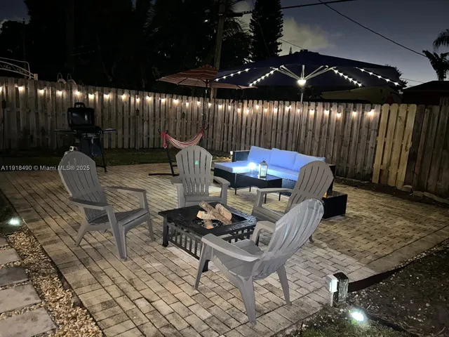 a outdoor space with lots of chairs and a table