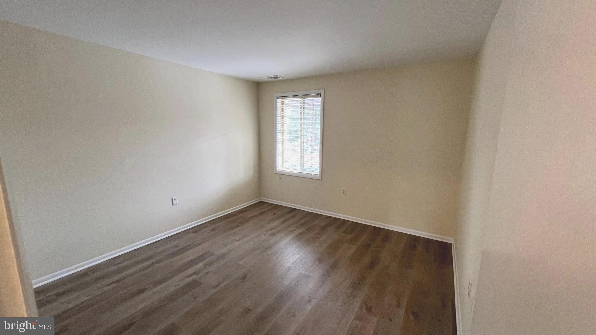10073 Windstream Drive, Unit 5 Columbia, MD 21044 - Photo 11 of 17 an empty room with wooden floor and windows