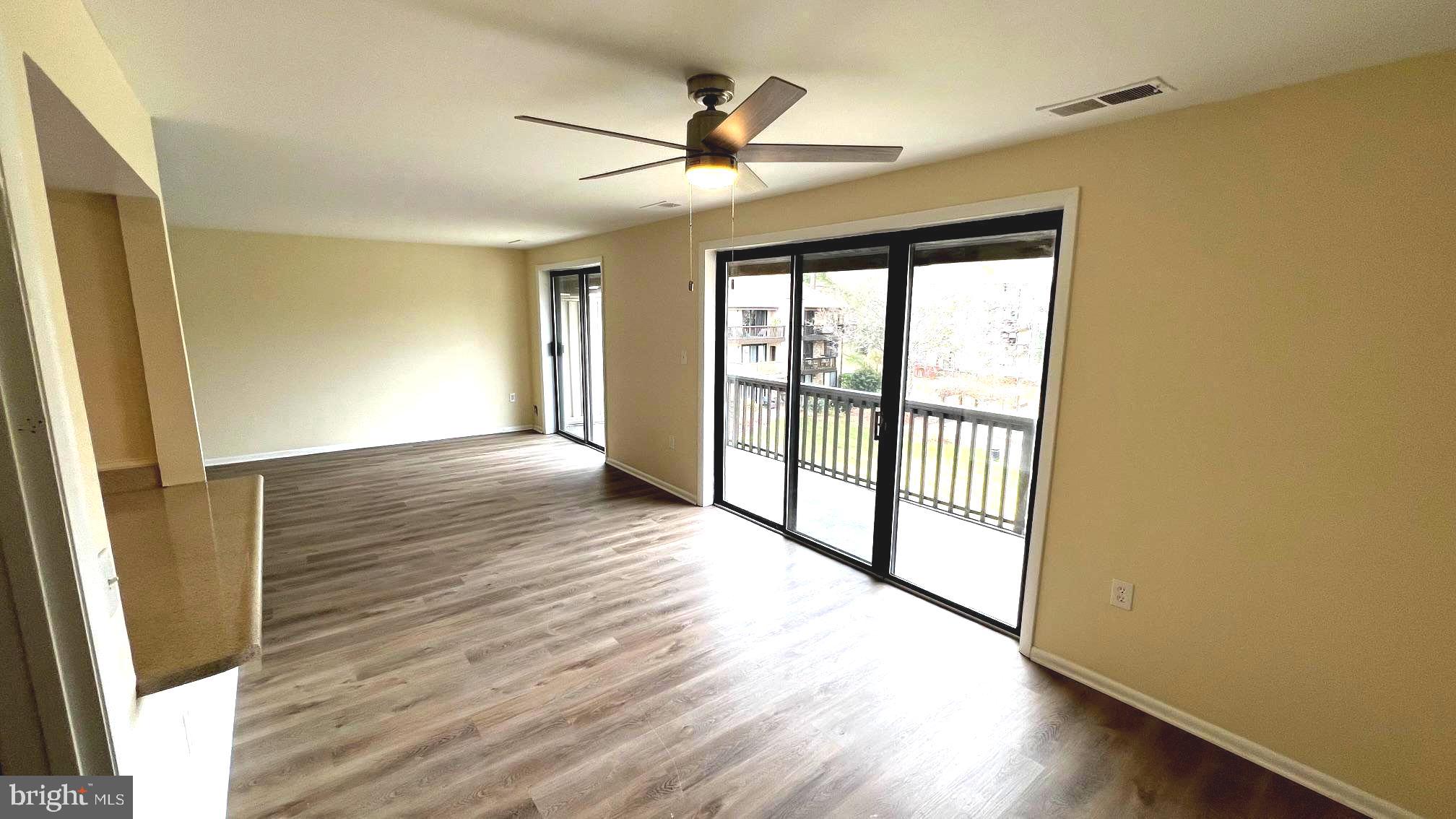 10073 Windstream Drive, Unit 5 Columbia, MD 21044 - Photo 3 of 17 wooden floor in an empty room with a window
