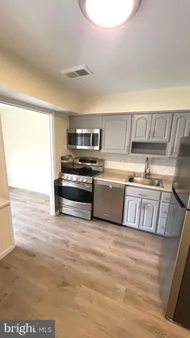 a kitchen with a refrigerator and a sink