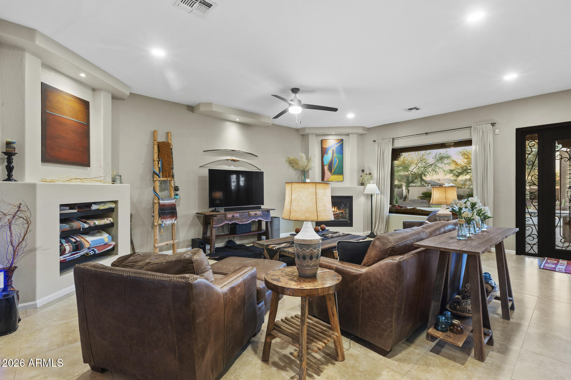 14526 West Jomax Road Surprise, AZ 85387 - Photo 13 of 57 a living room with fireplace furniture and a flat screen tv