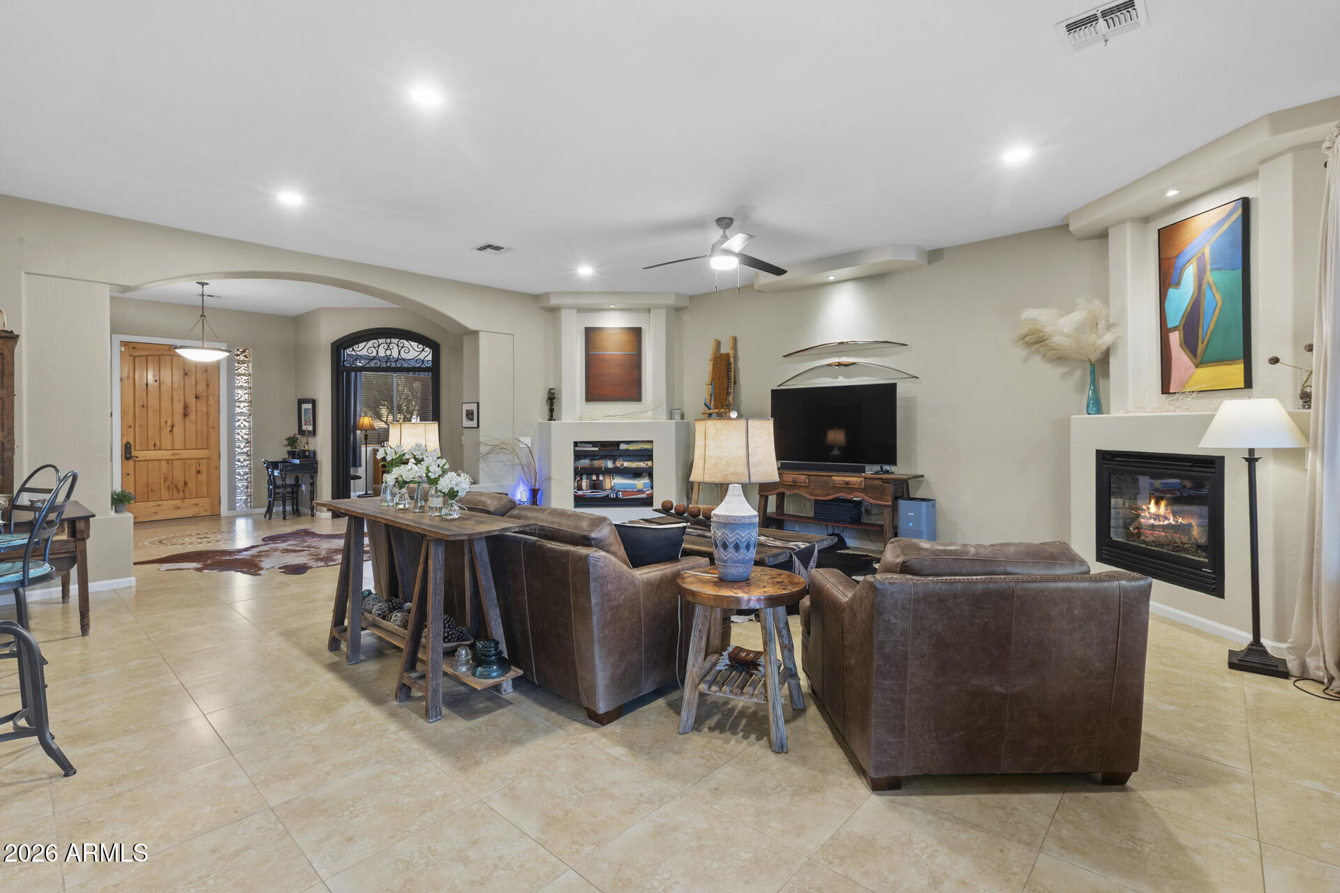 14526 West Jomax Road Surprise, AZ 85387 - Photo 14 of 57 a living room with furniture a flat screen tv and a fireplace