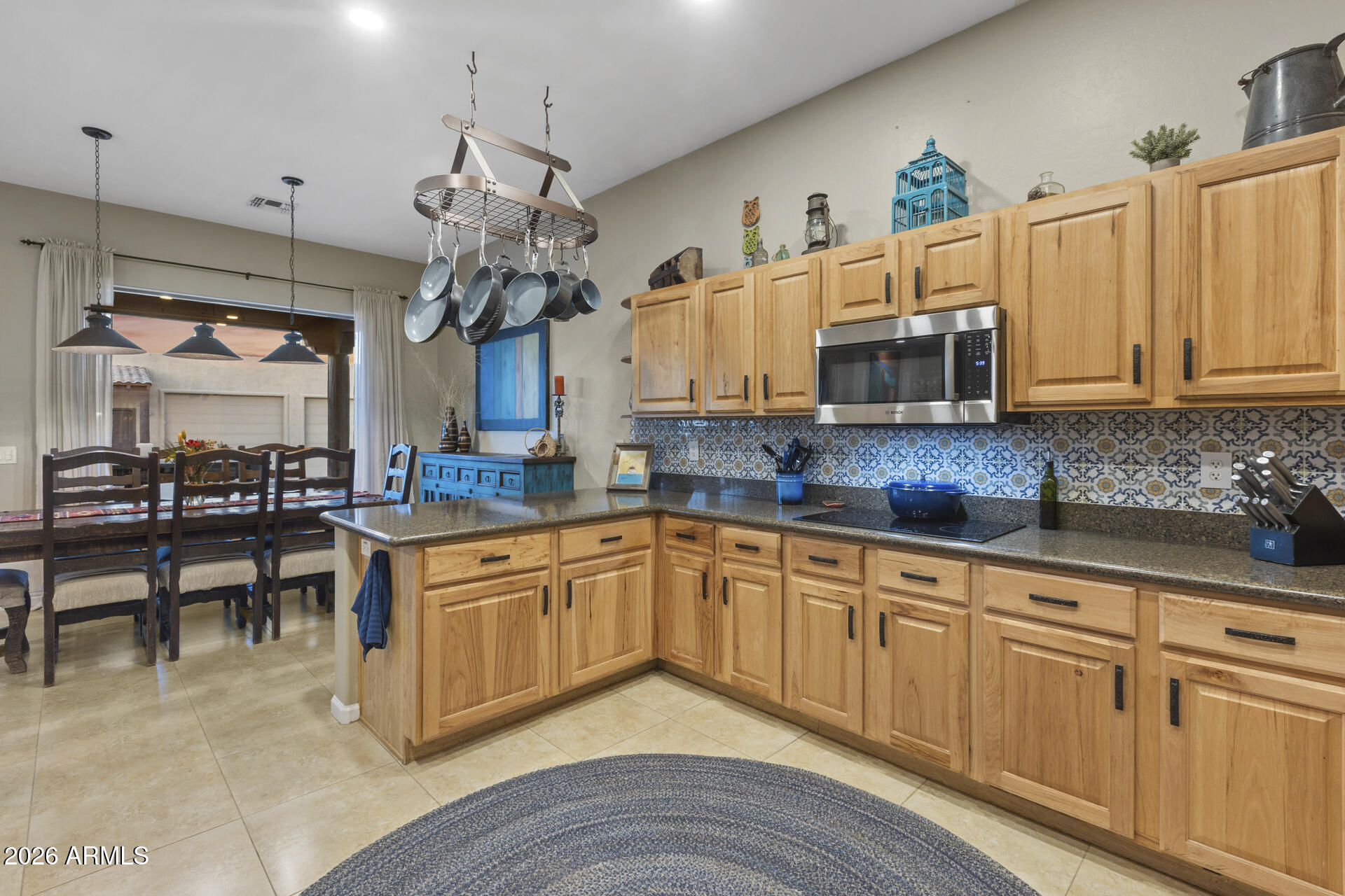 14526 West Jomax Road Surprise, AZ 85387 - Photo 17 of 57 a kitchen with kitchen island granite countertop a sink a counter space appliances and cabinets