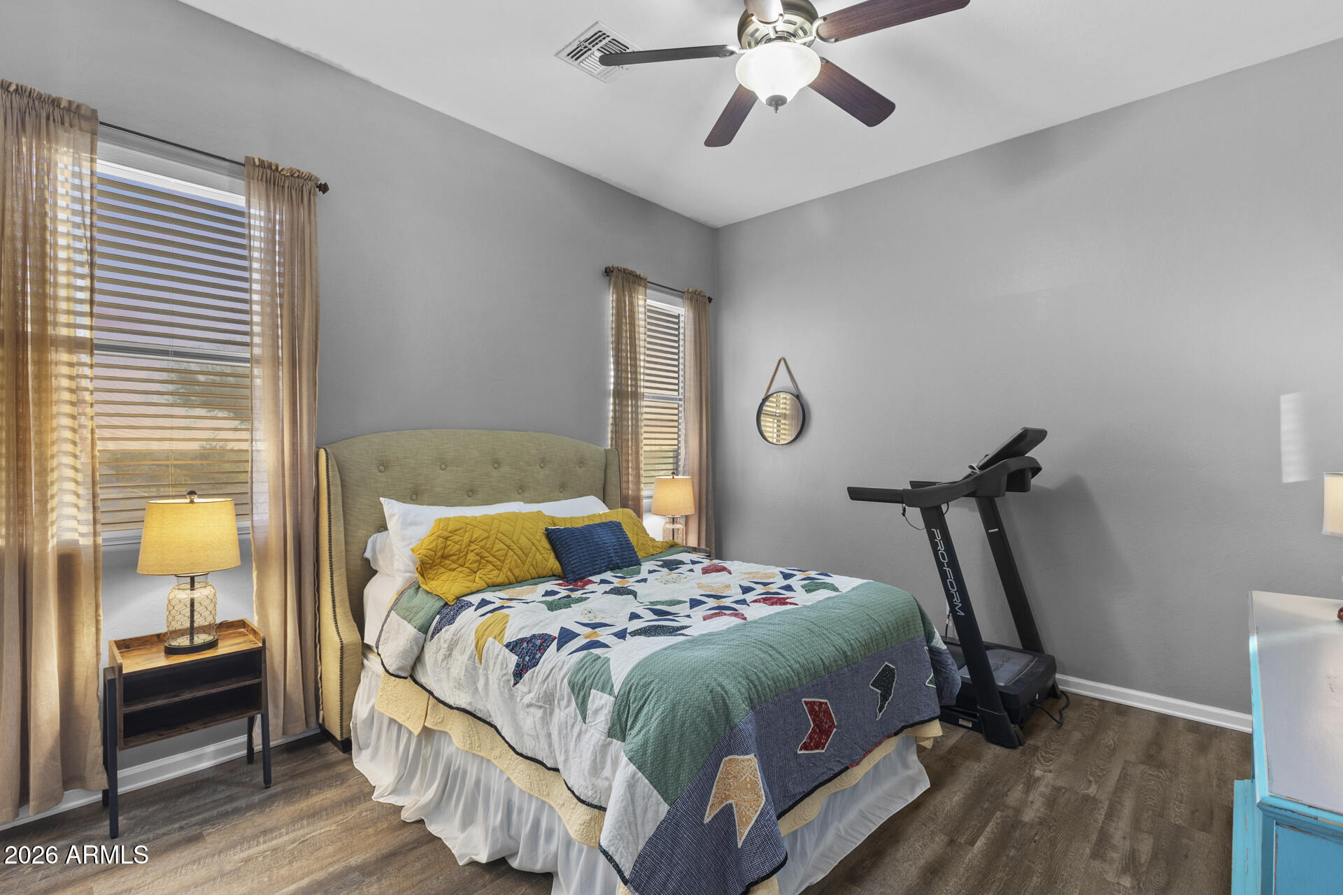 14526 West Jomax Road Surprise, AZ 85387 - Photo 25 of 57 a bedroom with a bed and a chandelier