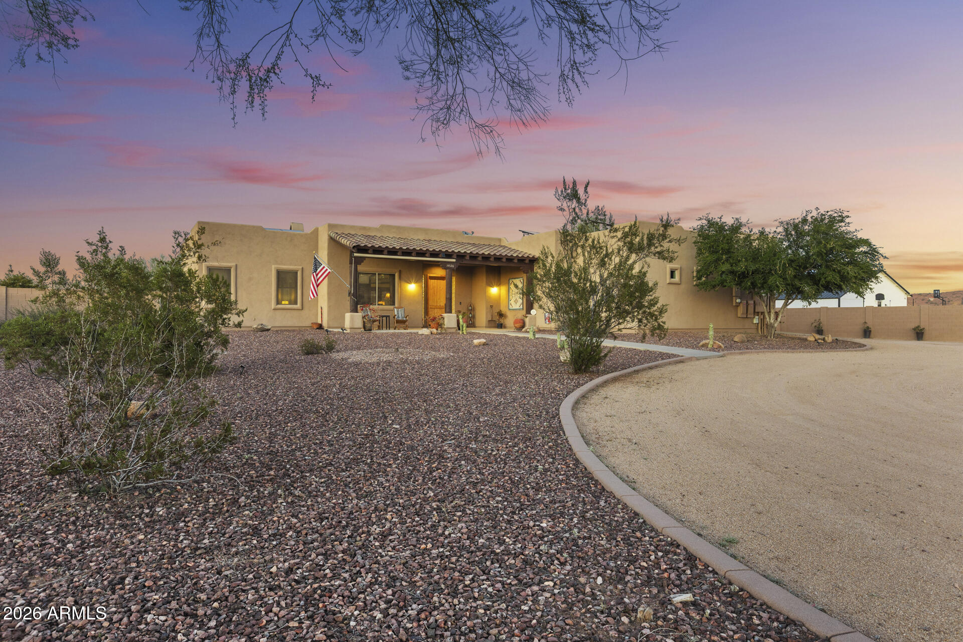 14526 West Jomax Road Surprise, AZ 85387 - Photo 2 of 57 a view of a house with backyard and trees