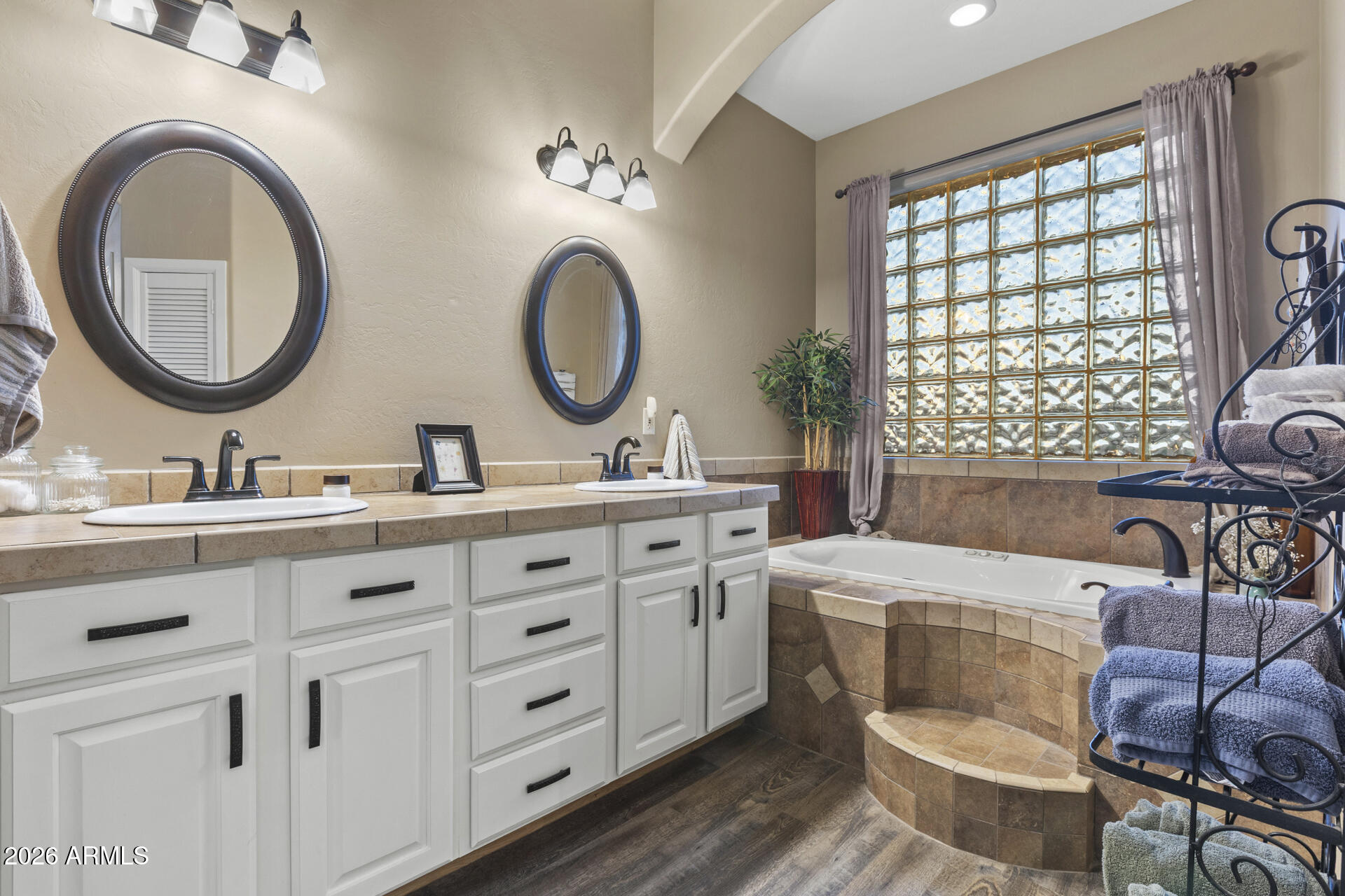 14526 West Jomax Road Surprise, AZ 85387 - Photo 33 of 57 a bathroom with a double vanity sink a toilet and a window