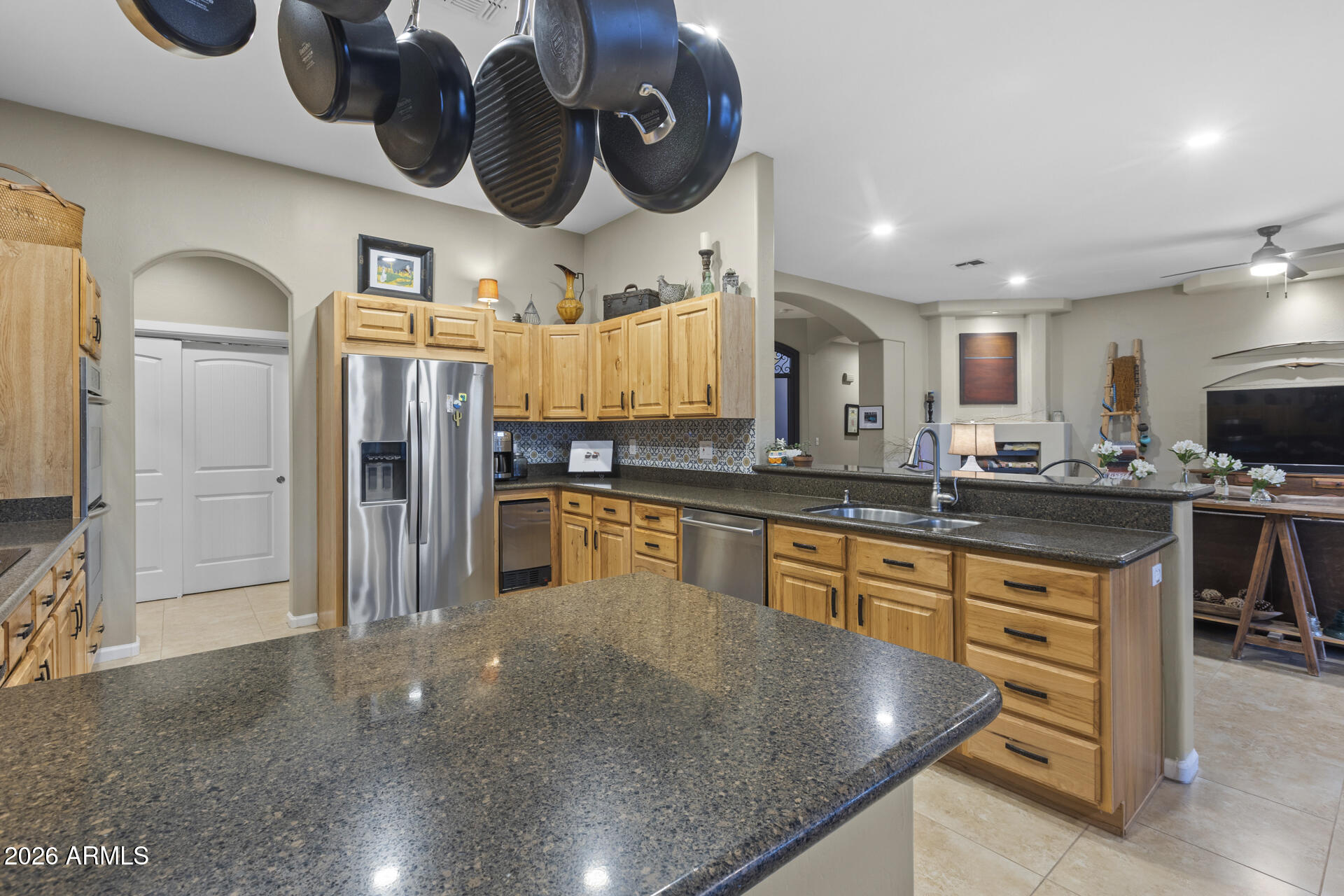 14526 West Jomax Road Surprise, AZ 85387 - Photo 4 of 57 a kitchen with stainless steel appliances granite countertop a sink a stove and a refrigerator