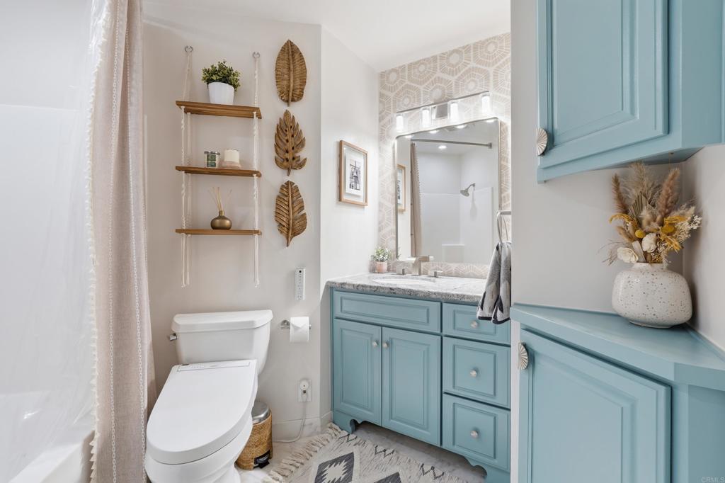 3051 Charwood Court Spring Valley, CA 91978 - Photo 12 of 20 a bathroom with a granite countertop toilet sink and mirror