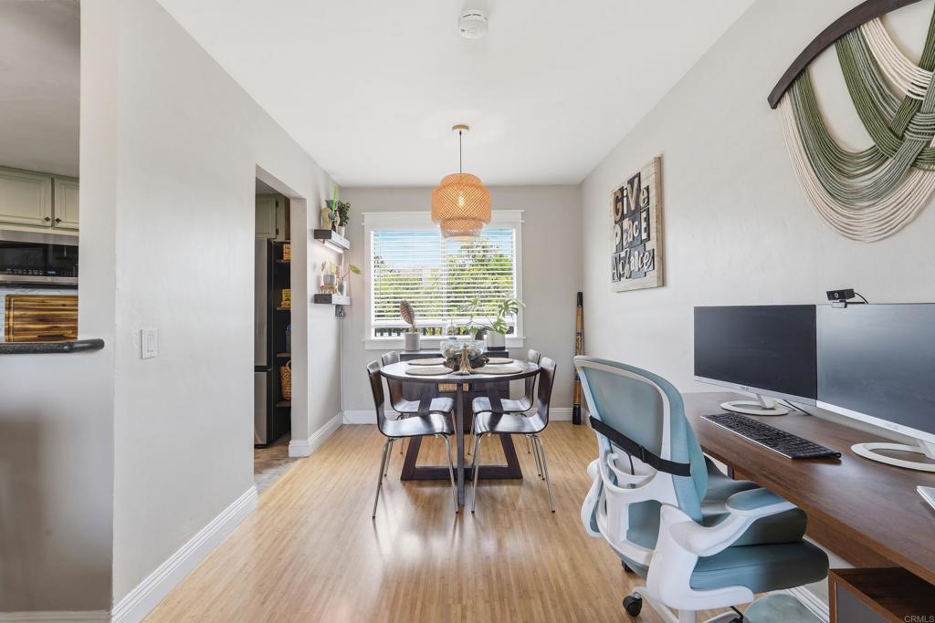 3051 Charwood Court Spring Valley, CA 91978 - Photo 3 of 20 a dining room with wooden floor a chandelier a wooden table and chairs