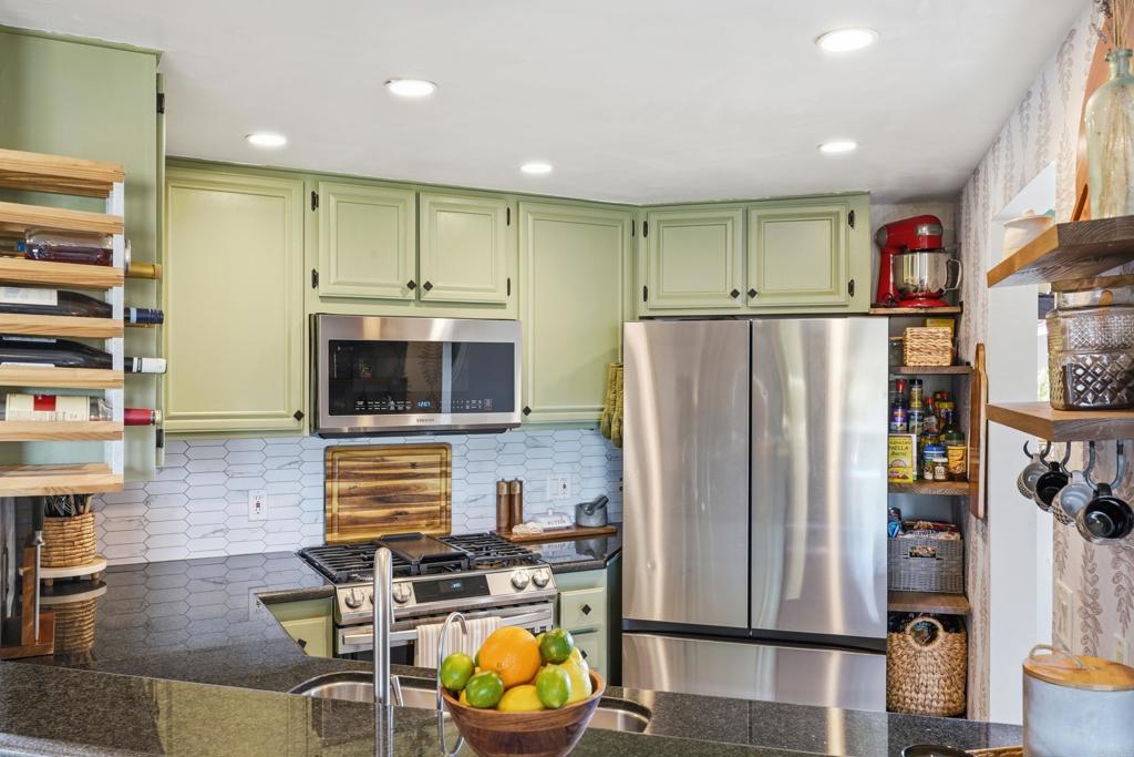 3051 Charwood Court Spring Valley, CA 91978 - Photo 4 of 20 a kitchen with stainless steel appliances granite countertop a refrigerator and a stove top oven