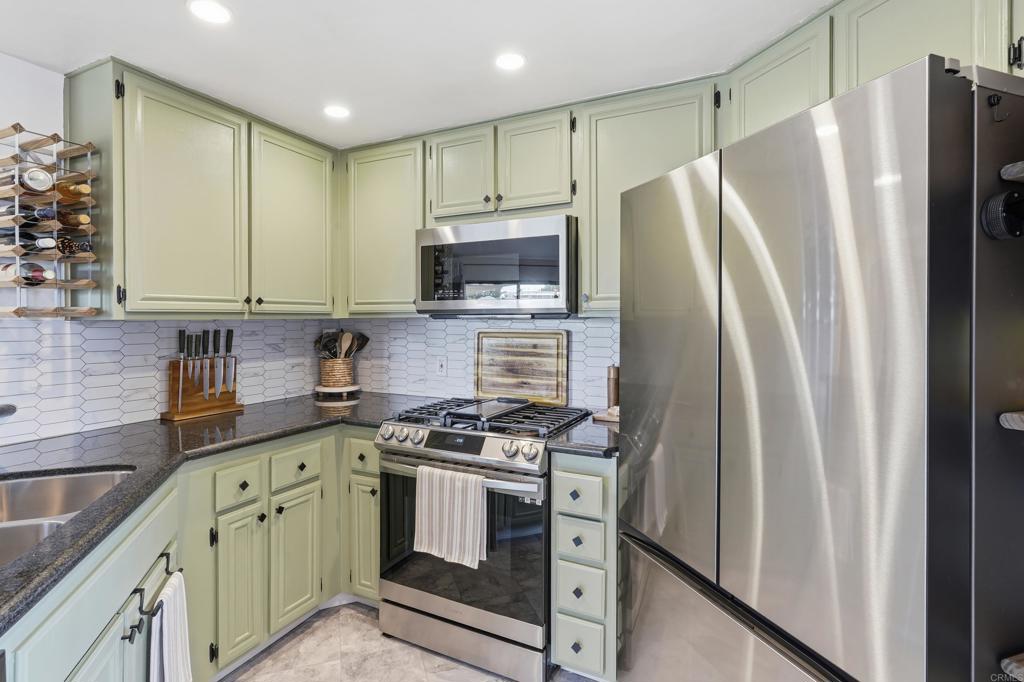 3051 Charwood Court Spring Valley, CA 91978 - Photo 5 of 20 a kitchen with stainless steel appliances a refrigerator stove and sink