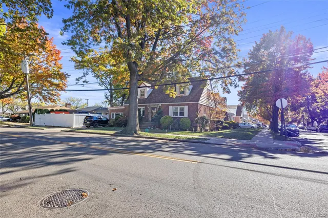 a street sign on a sidewalk next to a road