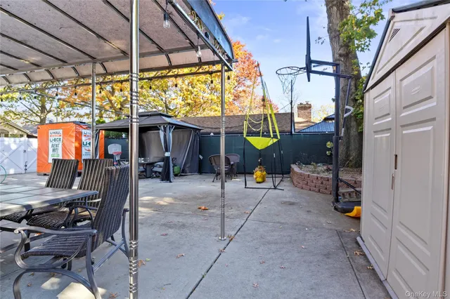 a view of backyard with a table and chairs