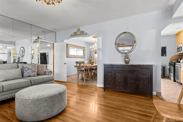 a living room with furniture a fireplace and wooden floor
