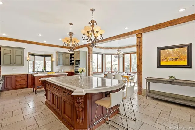 a dining hall with stainless steel appliances granite countertop a sink and a refrigerator