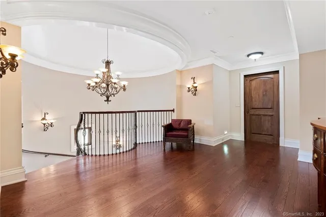 wooden floor with chandelier and window
