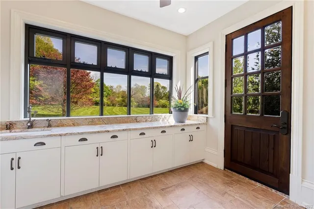 a kitchen with granite countertop a large window and a sink