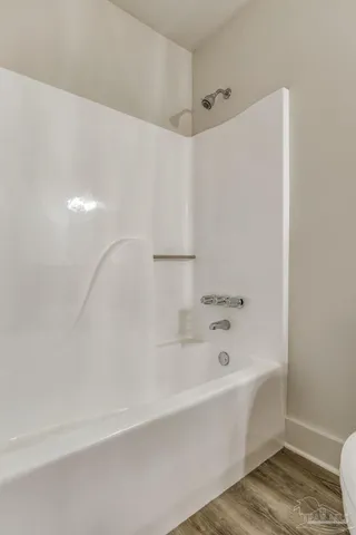 a bathroom with a bathtub and shower