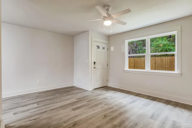 wooden floor in an empty room with a window